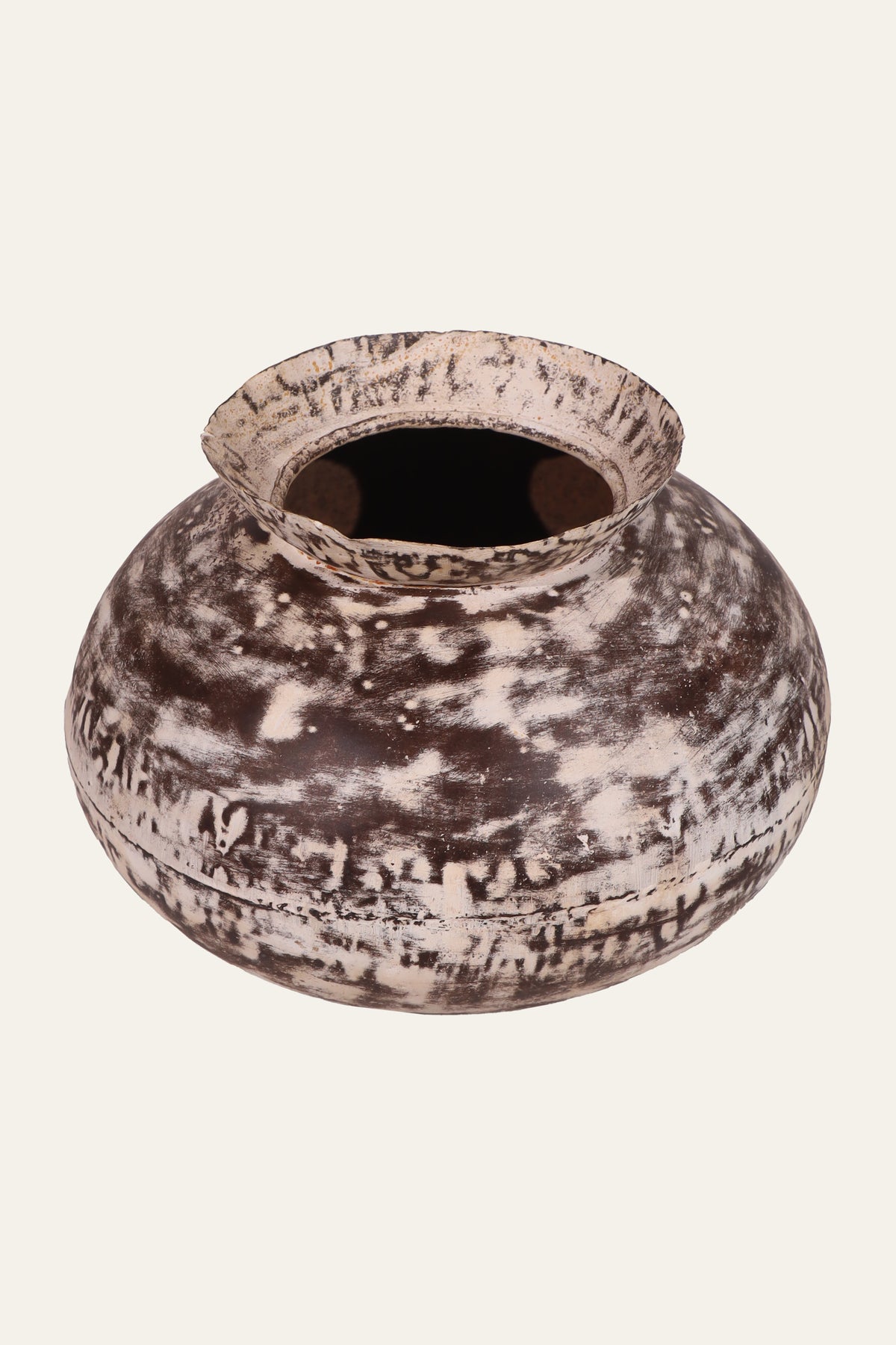 distressed white metal pot with blackened finish