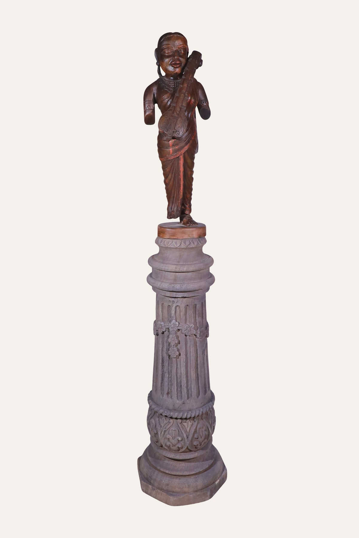 female musician figurine on pedestal