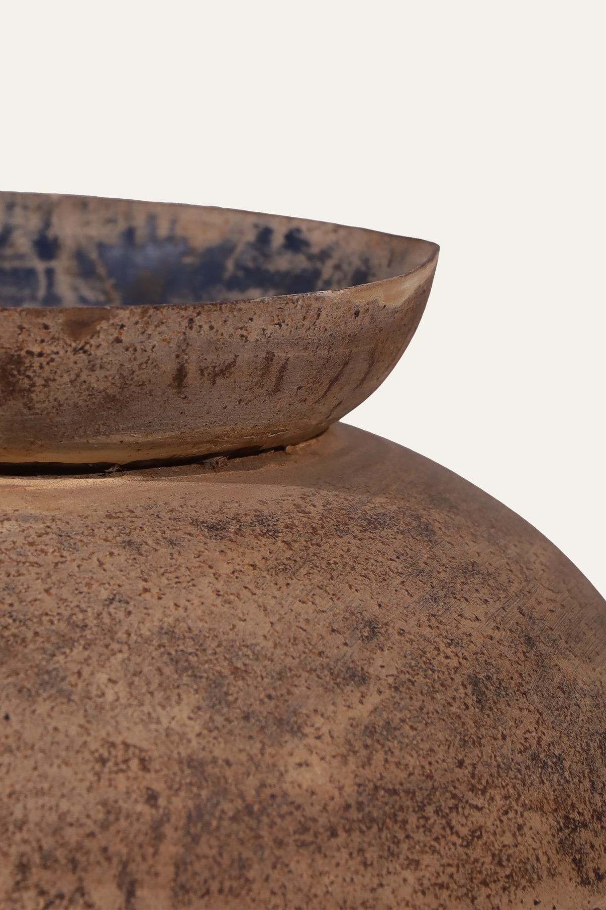 light brown metal pot with textured surface
