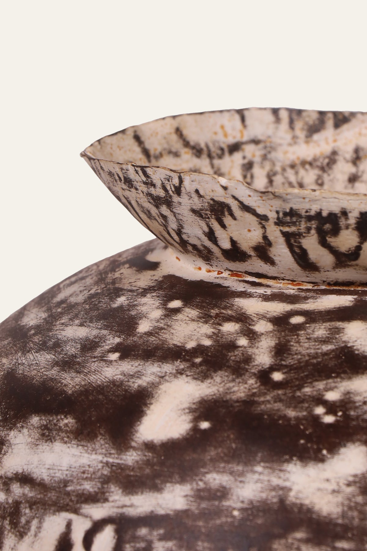 white metal pot with black brush accents