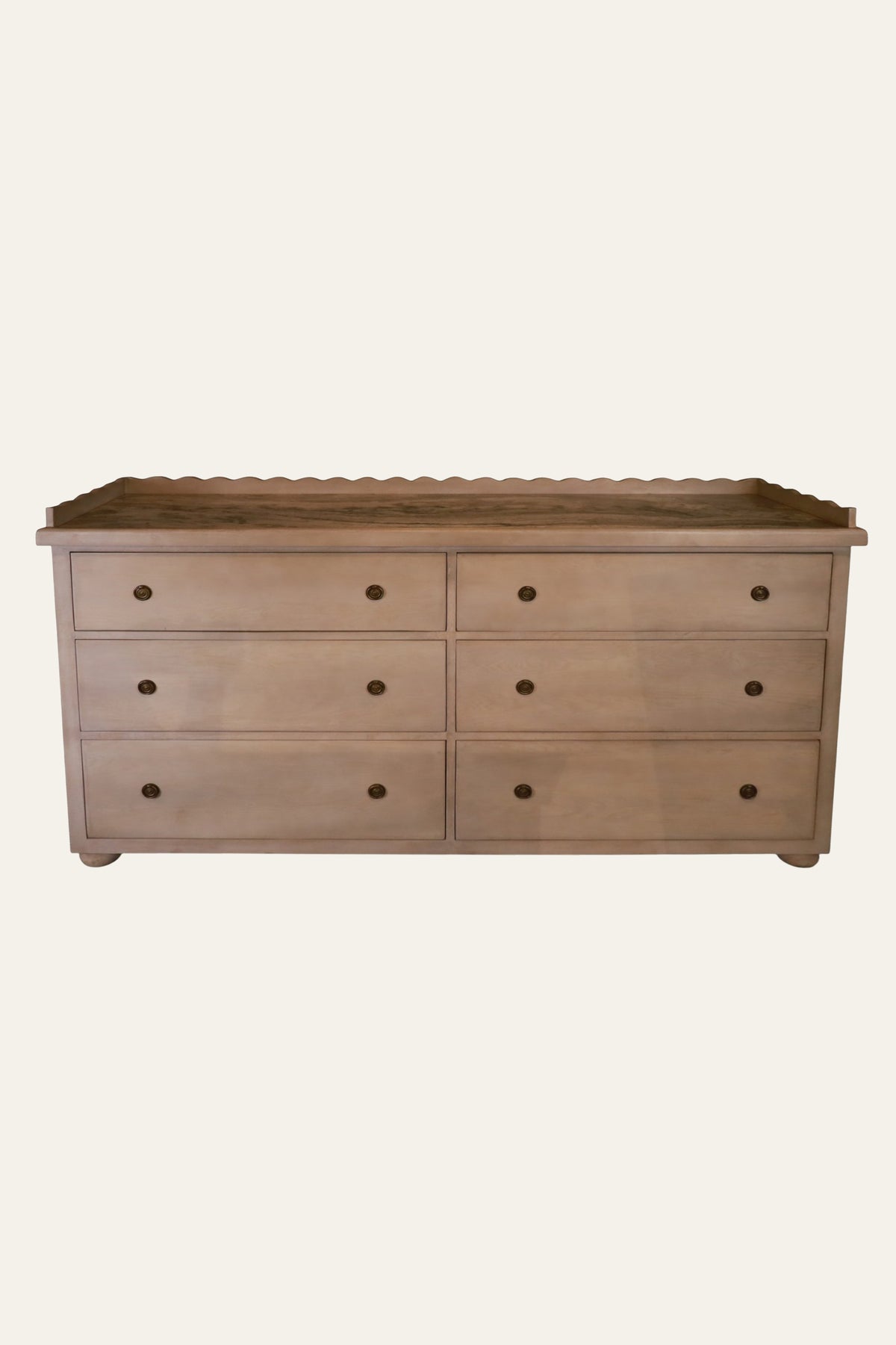 wooden chest of drawers with scalloped top
