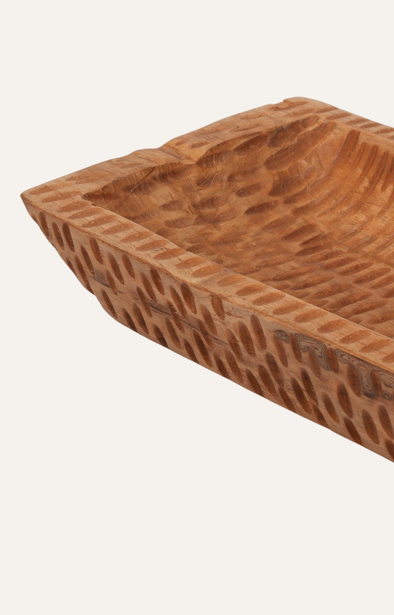 wooden tray with deeply carved patterns